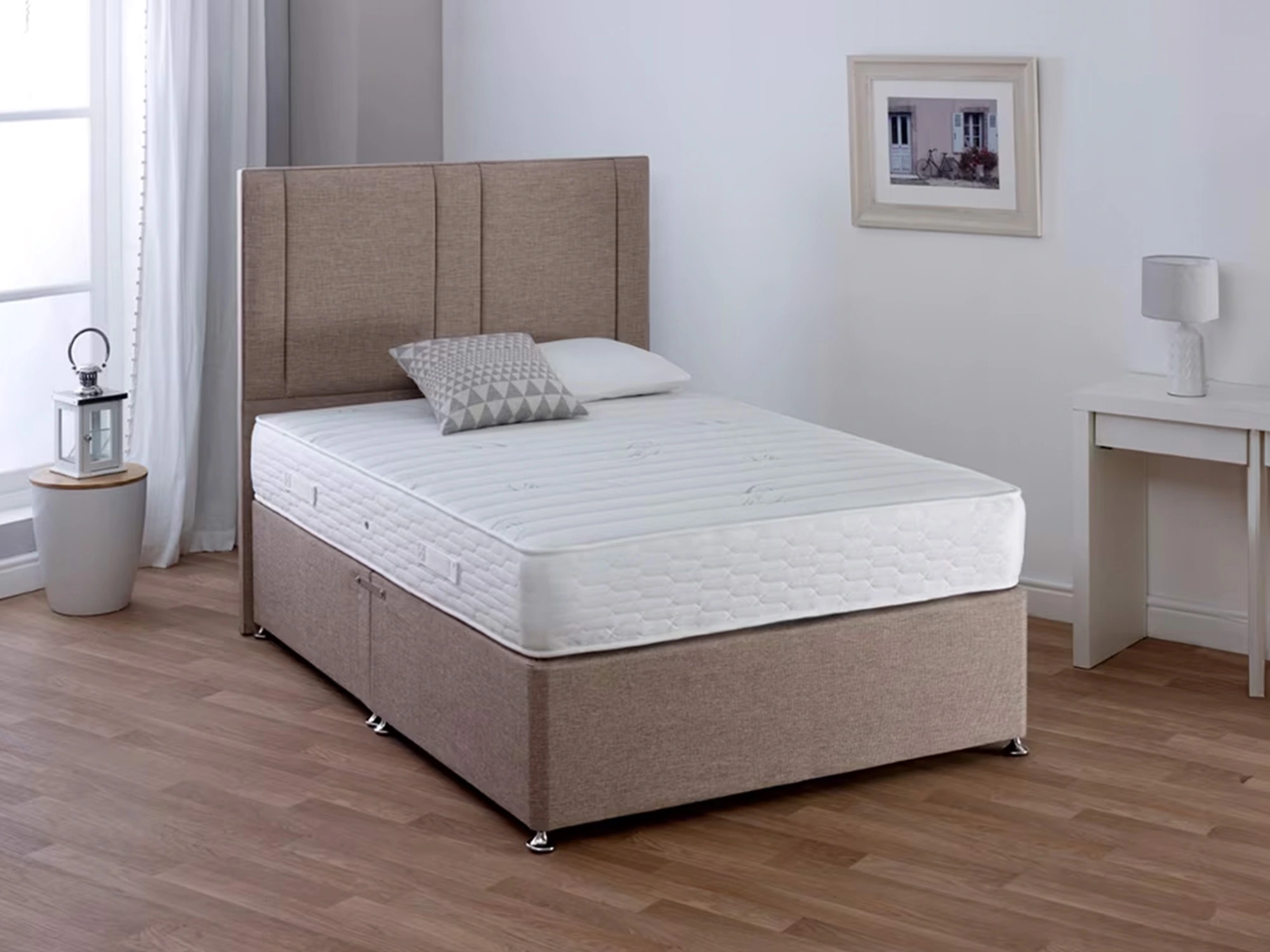 Angled view of Sealy Mellbreak Ortho Plus Mattress on a grey divan base with a stylish bedroom decor