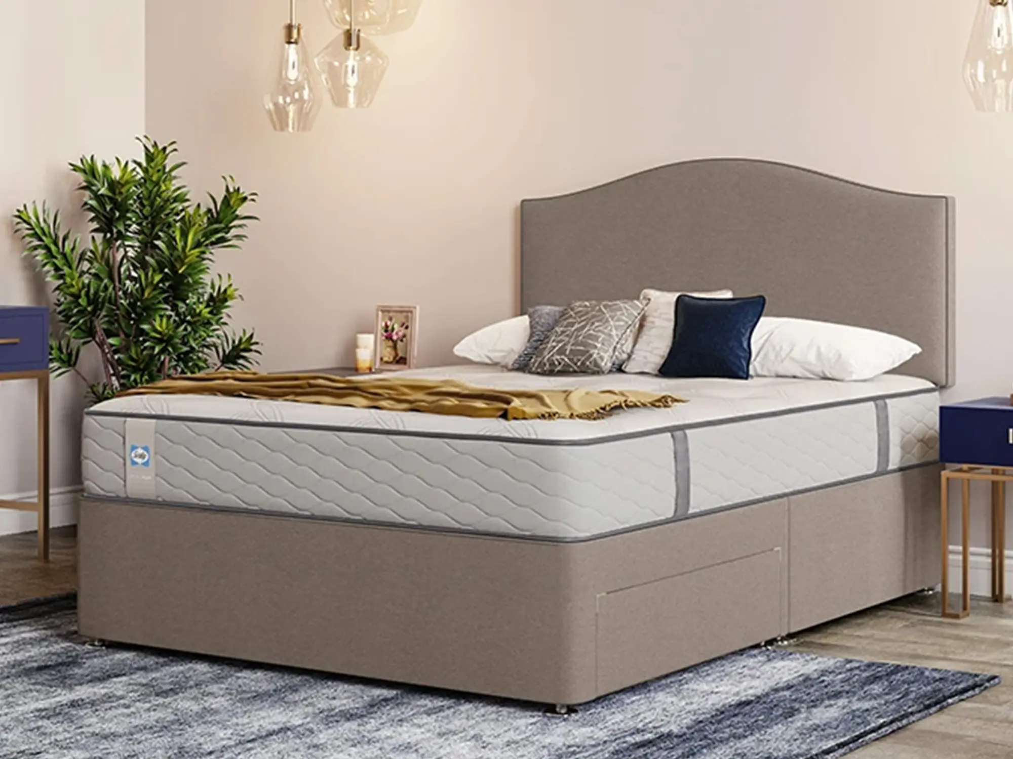 Sealy Mellbreak Mattress sat on a grey divan base in a stylish bedroom