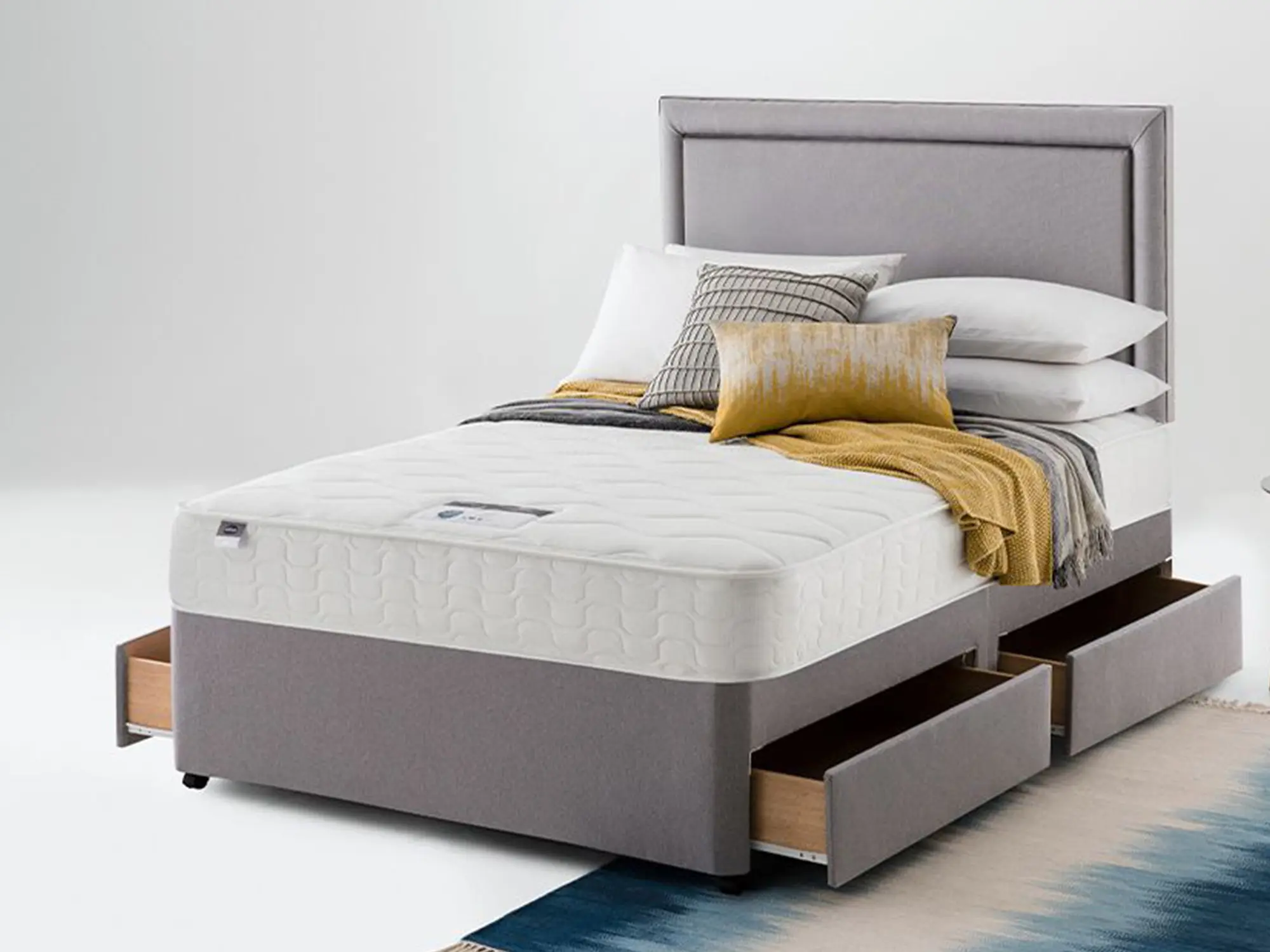 Silentnight 800 Miracpoket Mattress sat on a grey divan base in a neutral coloured bedroom